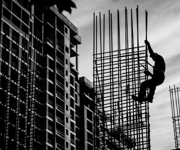 a perosn at the construction site working on a building