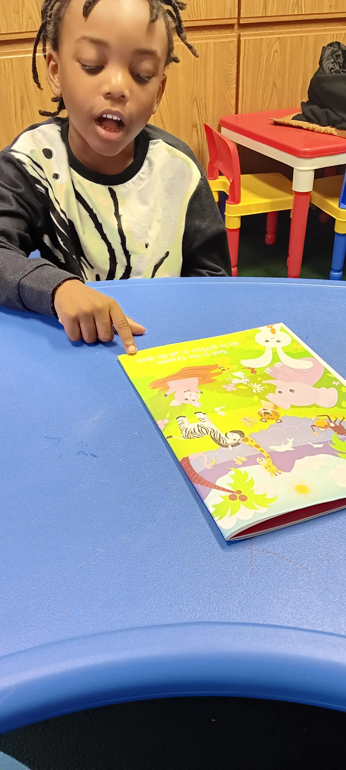 Boy picks paper out of different colored liquids