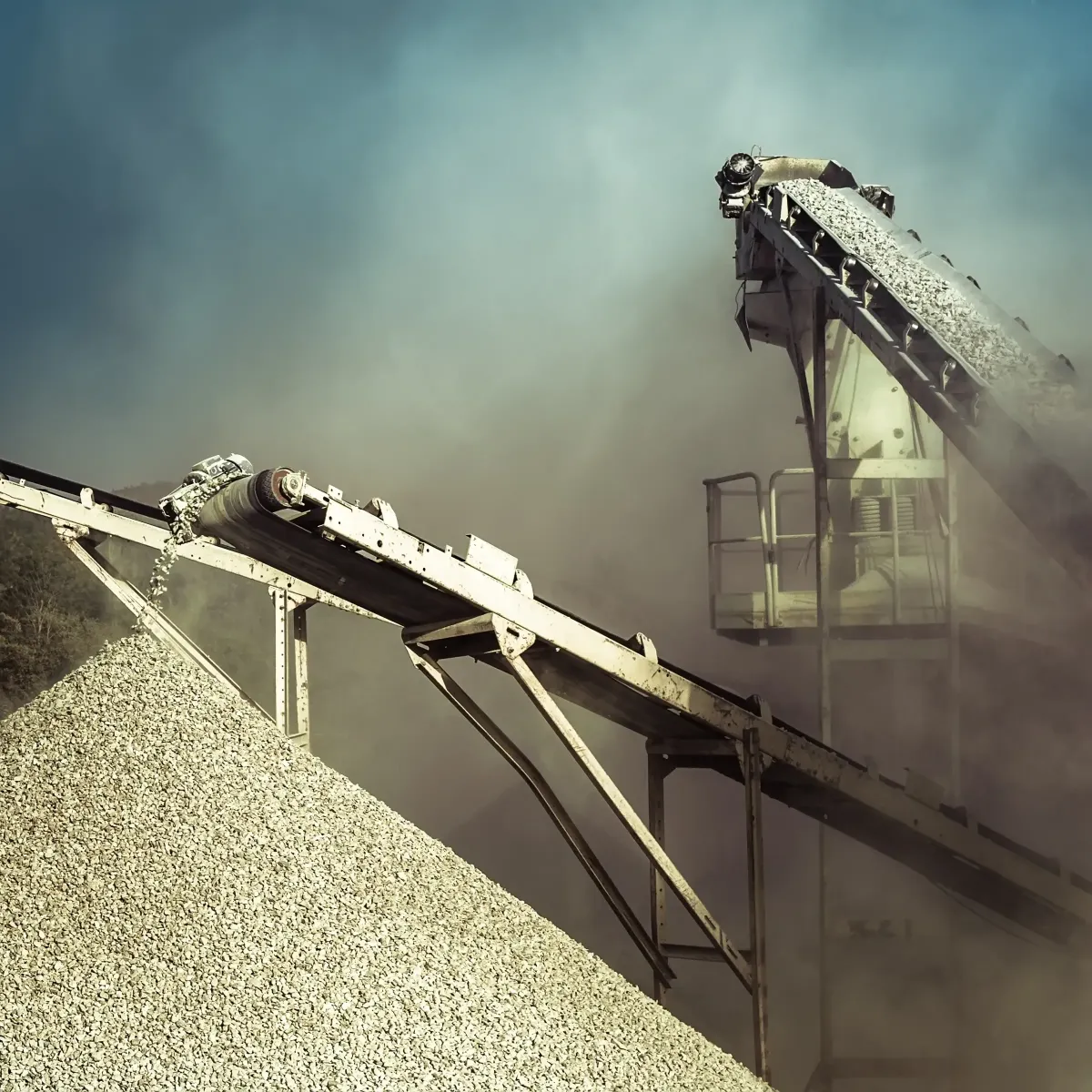 Industrial conveyor systems moving gravel at a manufacturing site, representing Centurion Insurance Services’ coverage for the Energy & Manufacturing sectors.