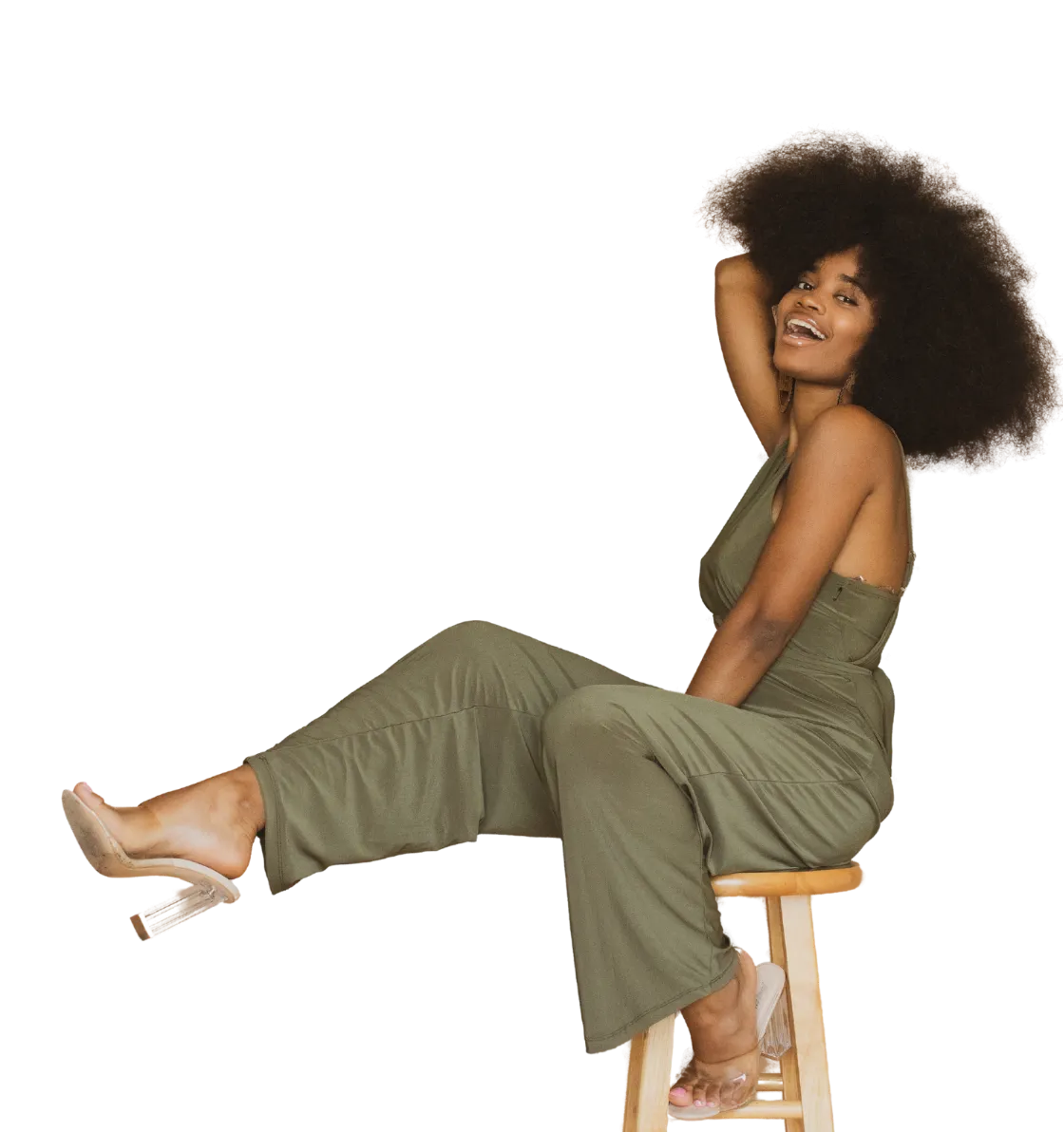 Confident Black woman smiling and seated with ease — representing clarity, self-belief, and bold transformation through the Free Unstuck & Unstoppable Workshop by Dr. Natasha Booker.