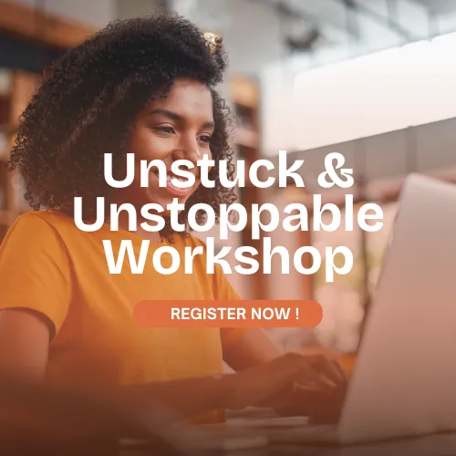 Black woman smiling while attending Dr. Natasha Booker’s Unstuck & Unstoppable workshop — live coaching for Black women ready to move forward with purpose.