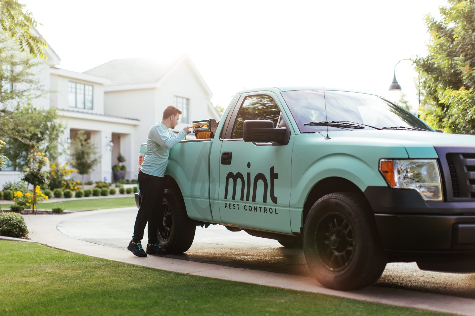Mint Pest Control technician inspecting a commercial property for pest activity