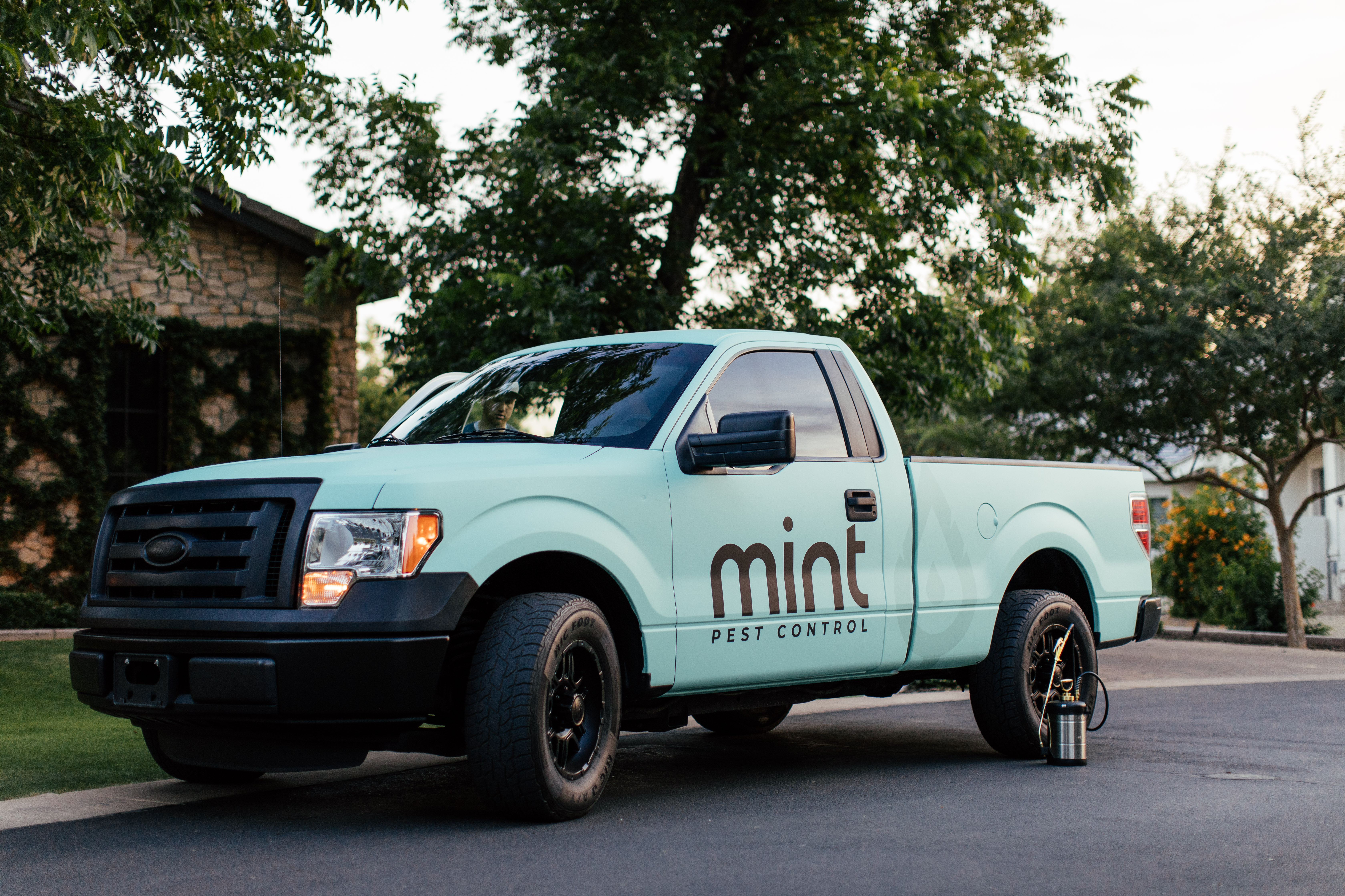 Mint Pest Control service truck parked outside a property in Fishers