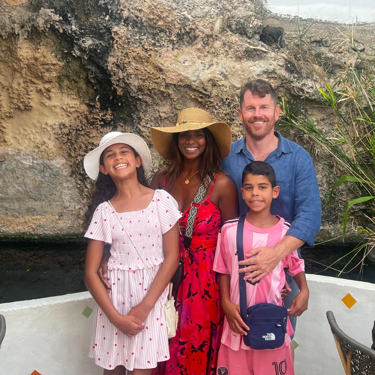 Founder portrait, male, mid-40s, Hispanic, three-quarter pose in a modern office, soft natural window light, holding property blueprints, approachable confident expression