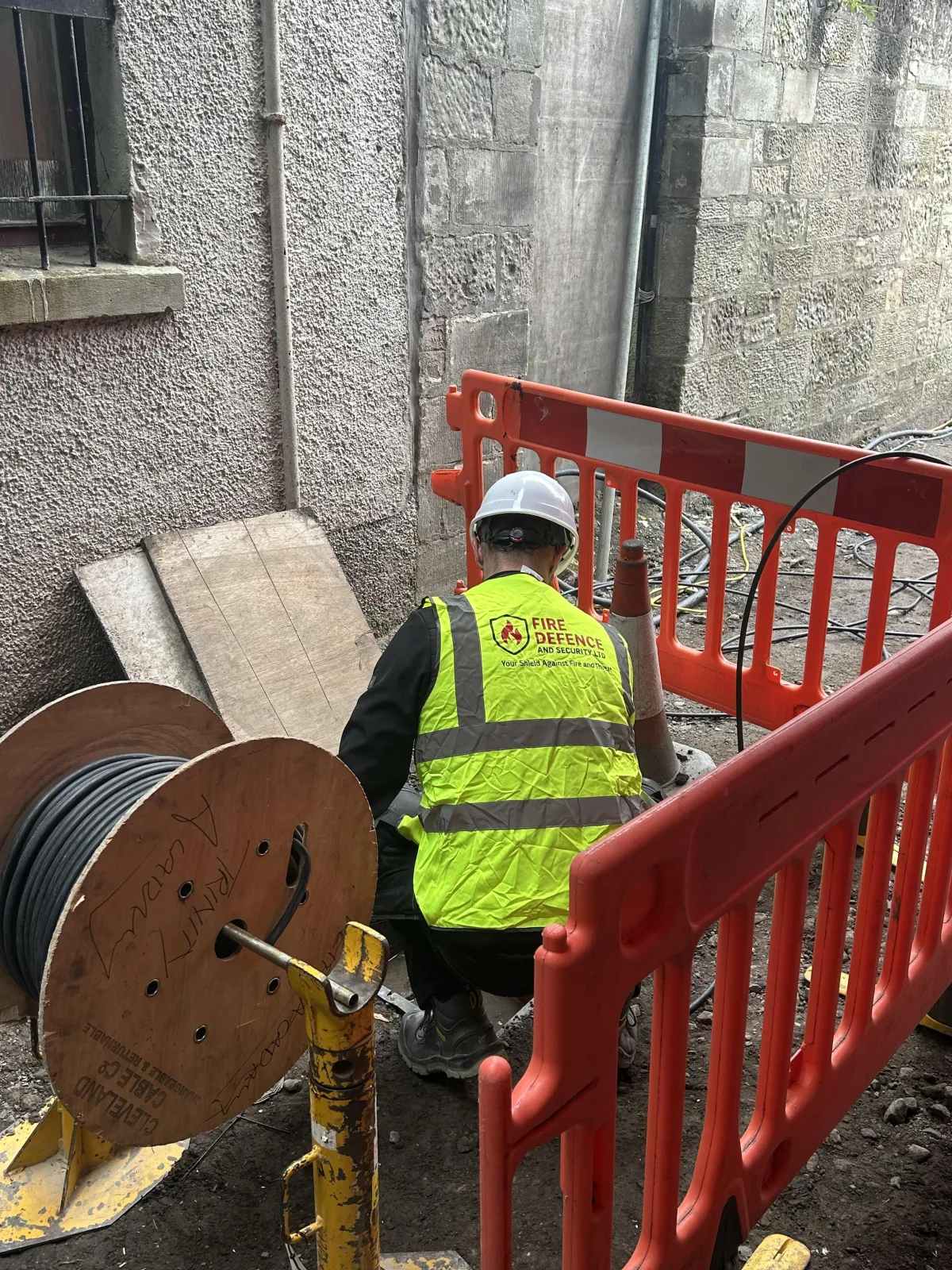 Fire Defence engineers setting up commercial CCTV camera on business premises exterior