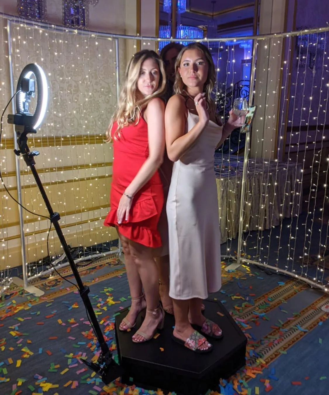 Elegantly decorated photobooth setup at an Atlanta wedding, with a backdrop of lights and confetti