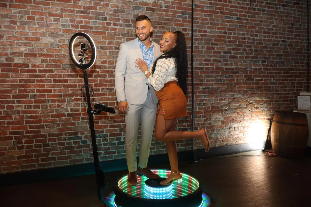 Man and woman on a 30 photoboth having fun at an event in Atlanta