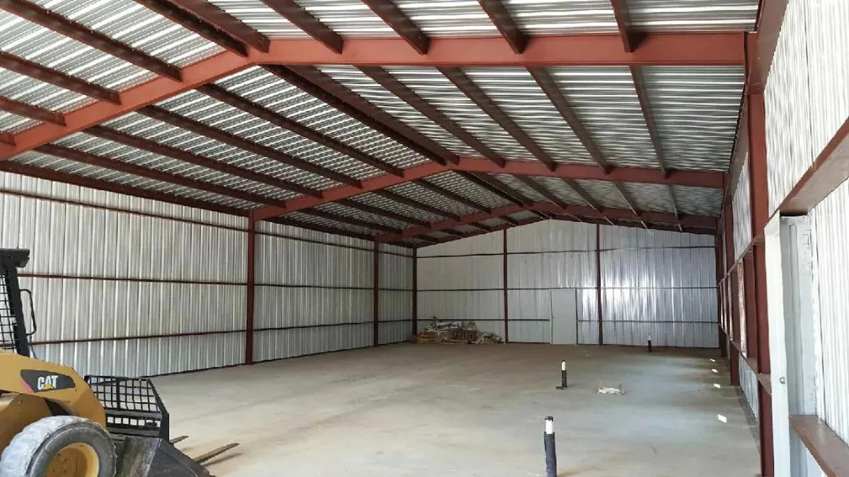 Inside of metal building with concrete floors build by Flores Roofing & Construction