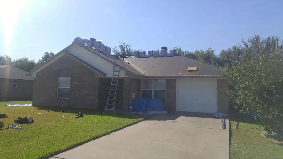 Roof with ladders and shingles ready for roof replacement