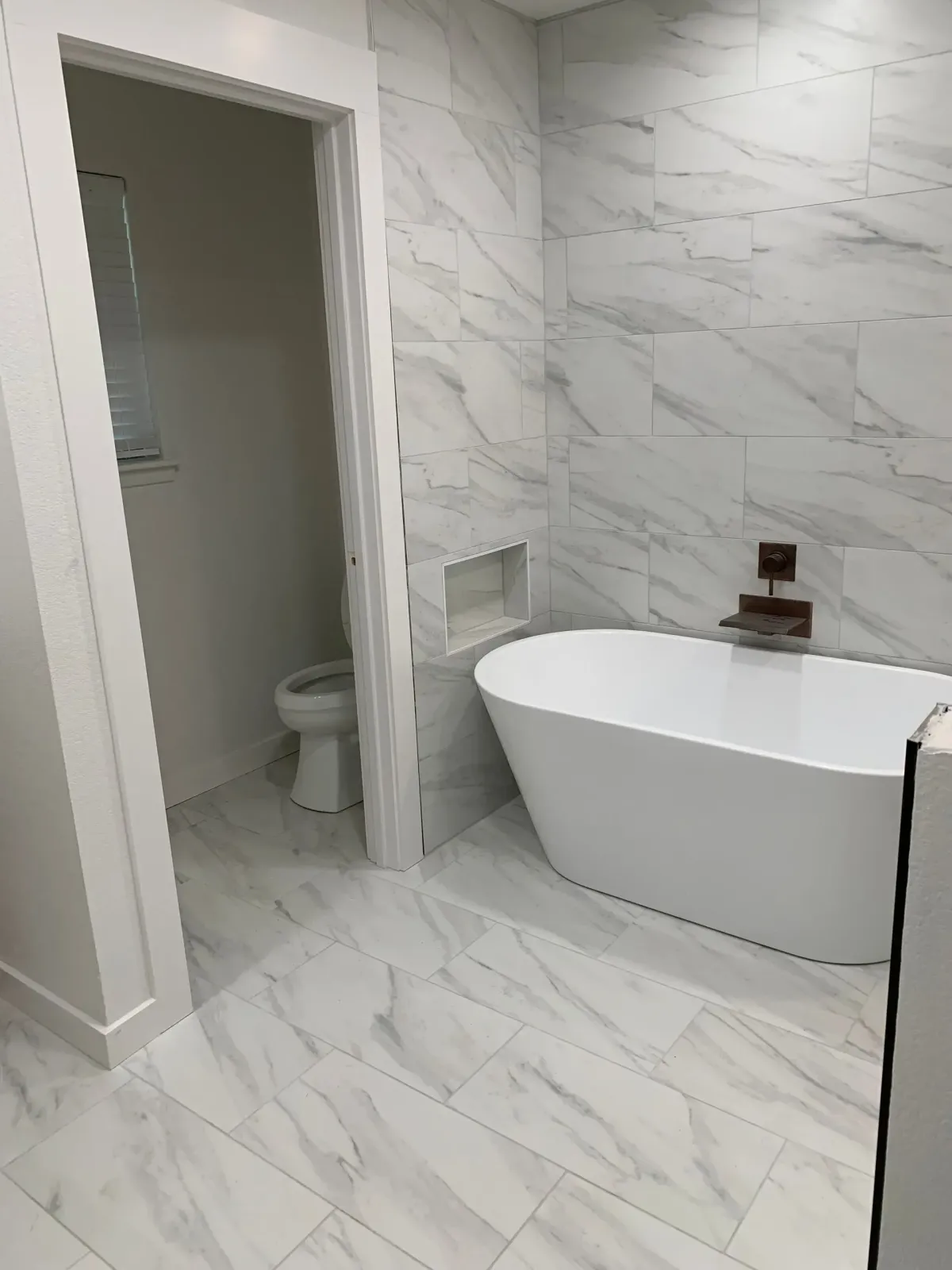 Full bathroom remodel with white floor to wall tiling