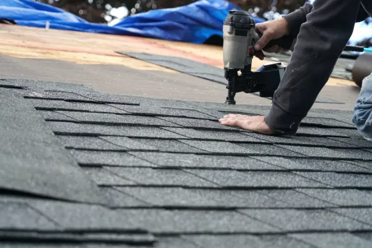 Gutters rolling out of truck being cut to size