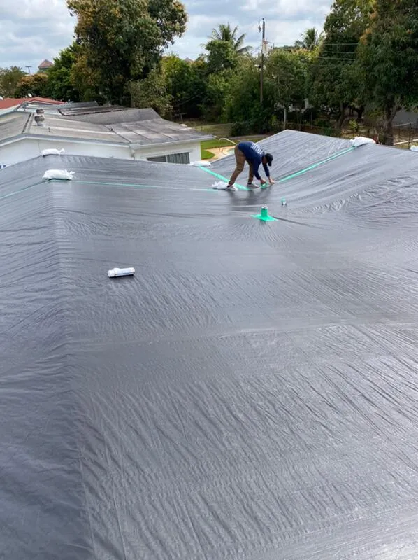 Gutters rolling out of truck being cut to size