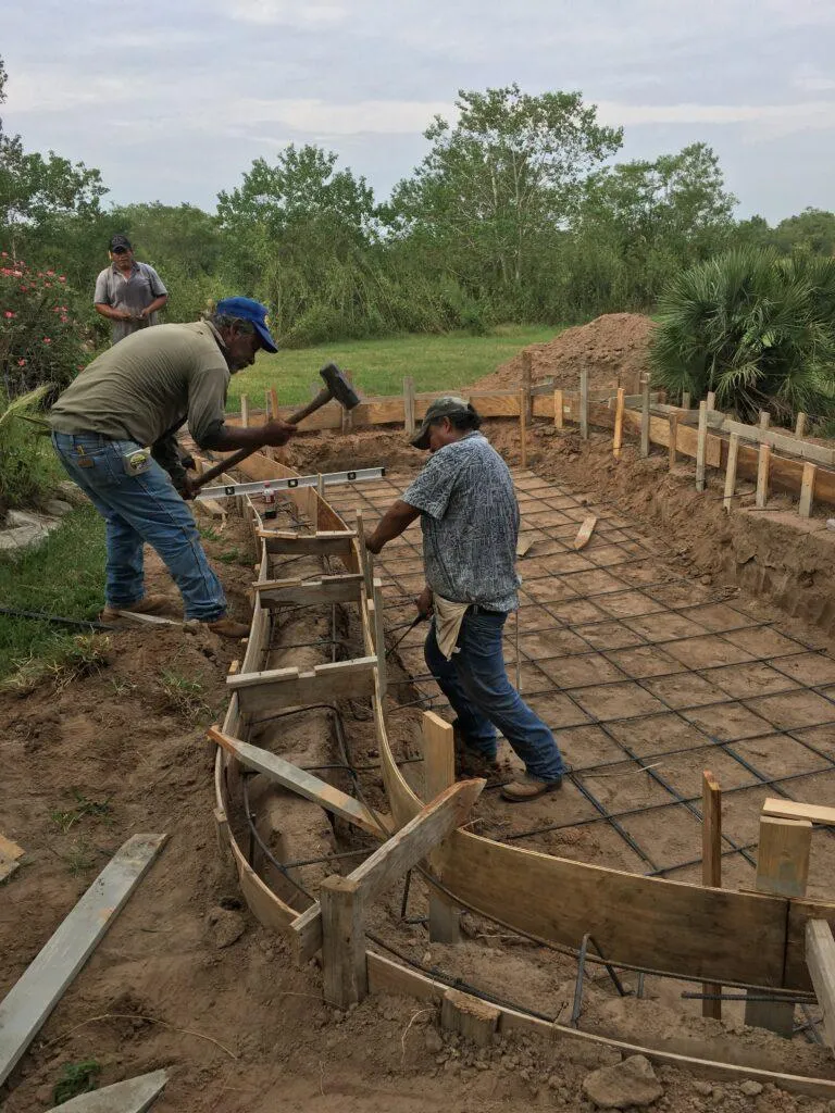 Gutters rolling out of truck being cut to size