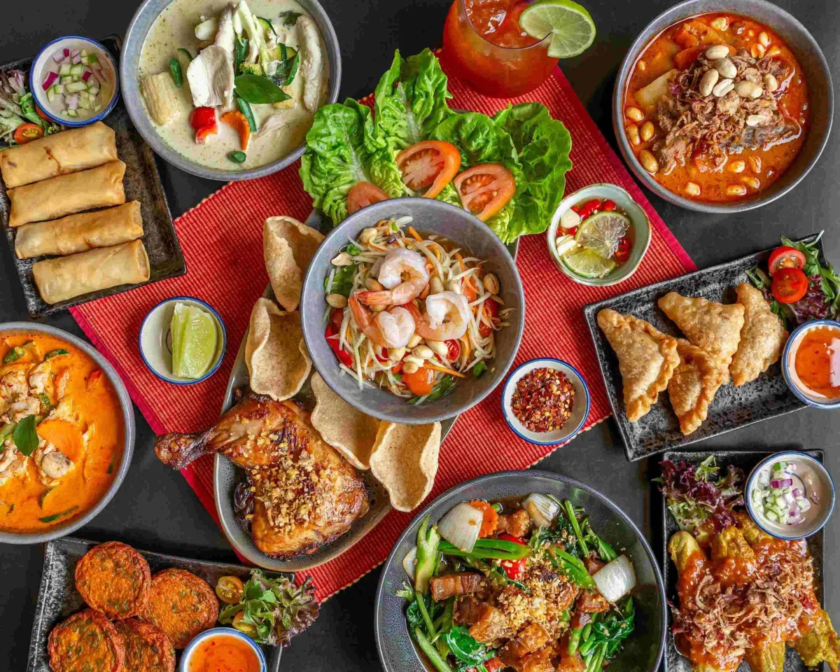 A white plate topped with food and sauce