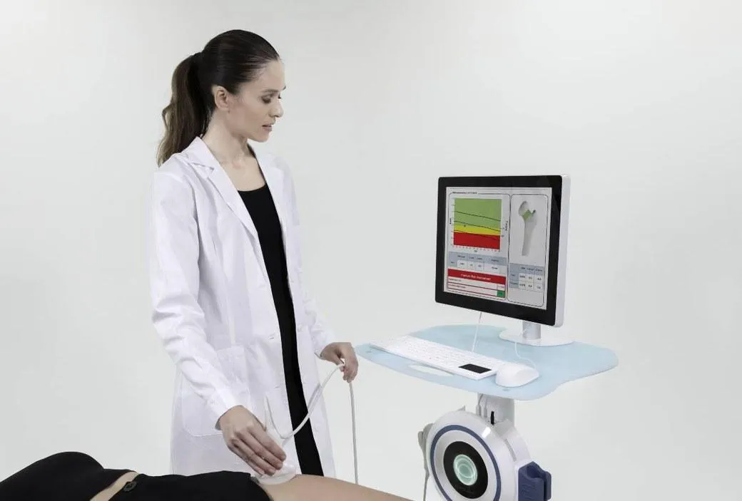 Technician performing a REMS bone density scan using Echolight ultrasound technology.