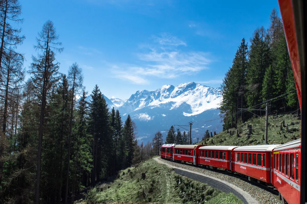 Scenic passenger train traveling through the mountains for rail vacation planning