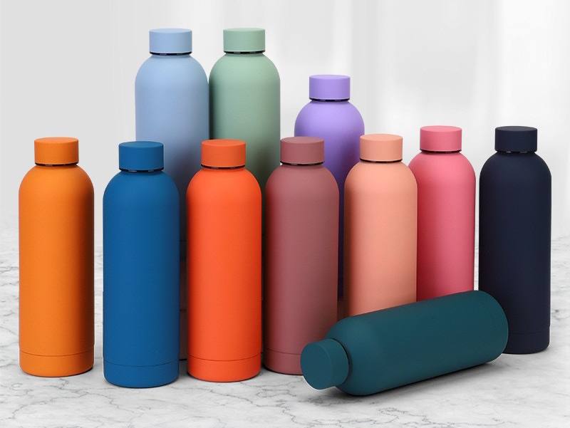 A ring rests on a textured rock with flowers.