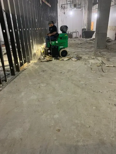 House demolition in Myrtle Beach, SC showing heavy machinery dismantling a sturdy residence with Southern architecture nearby.