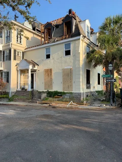 Demolished house in Myrtle Beach SC shows debris and exposed frames under a clear sky, highlighting the demolition process.