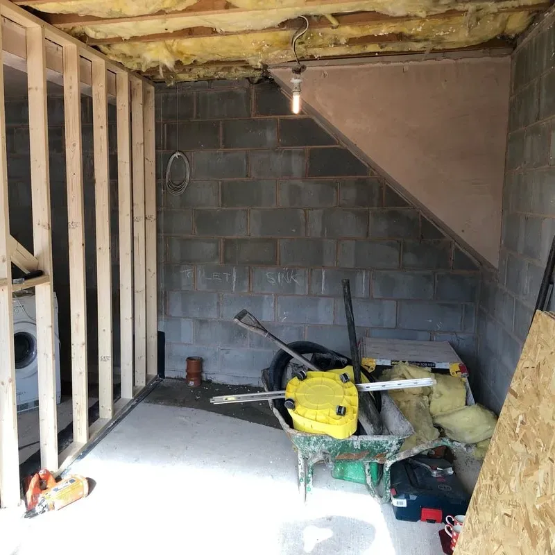 Modern Myrtle Beach garage conversion with sleek flooring, neutral walls, stylish furniture, large windows, coastal views, and landscaped yard