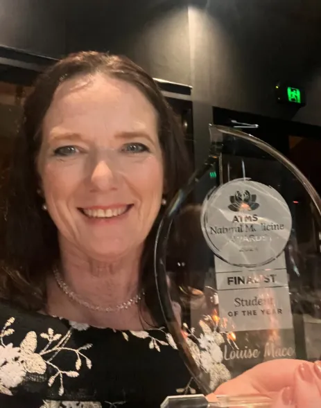 Louise Mace holding an award