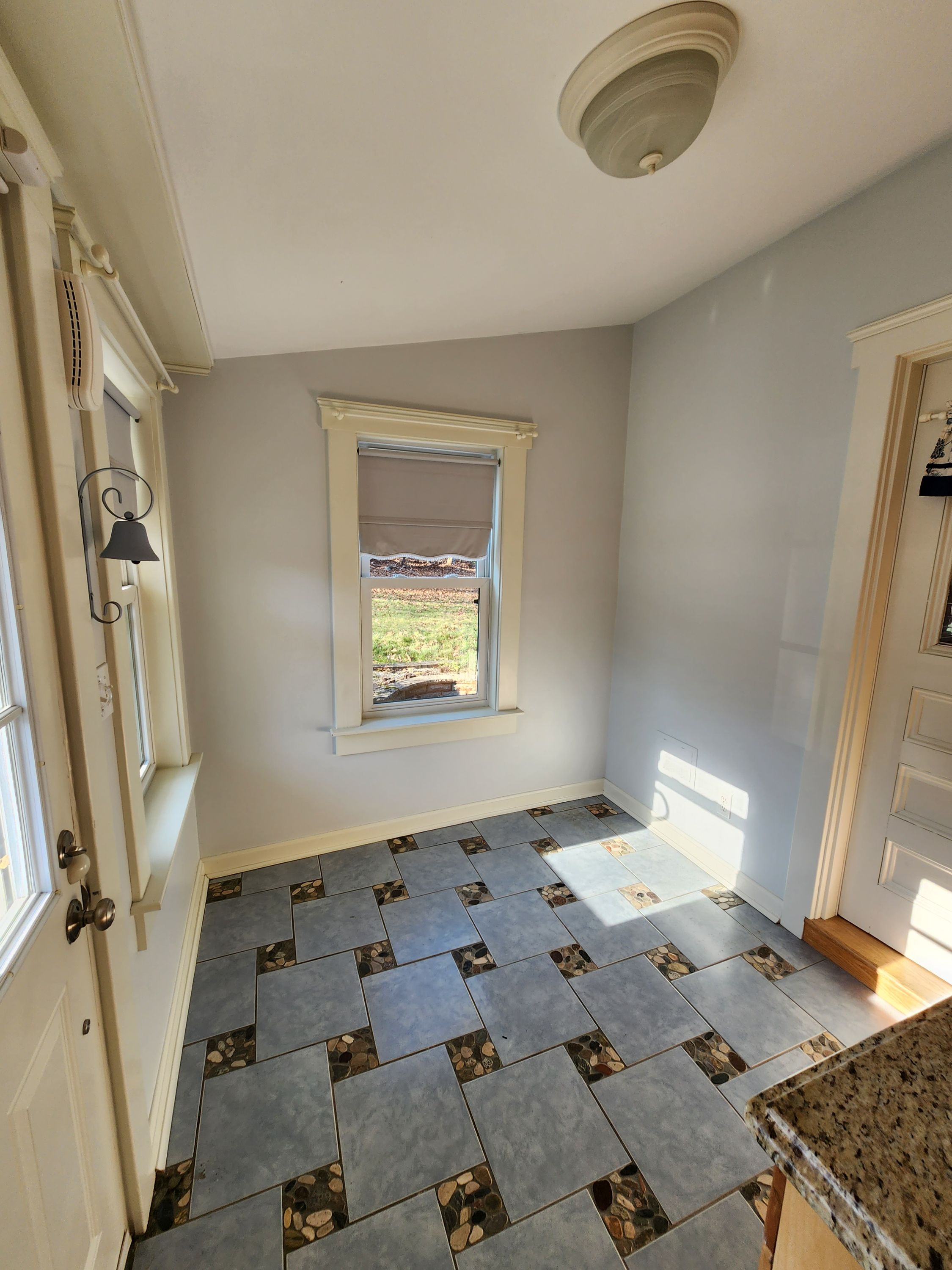 Small room with patterned tile floor and natural light window