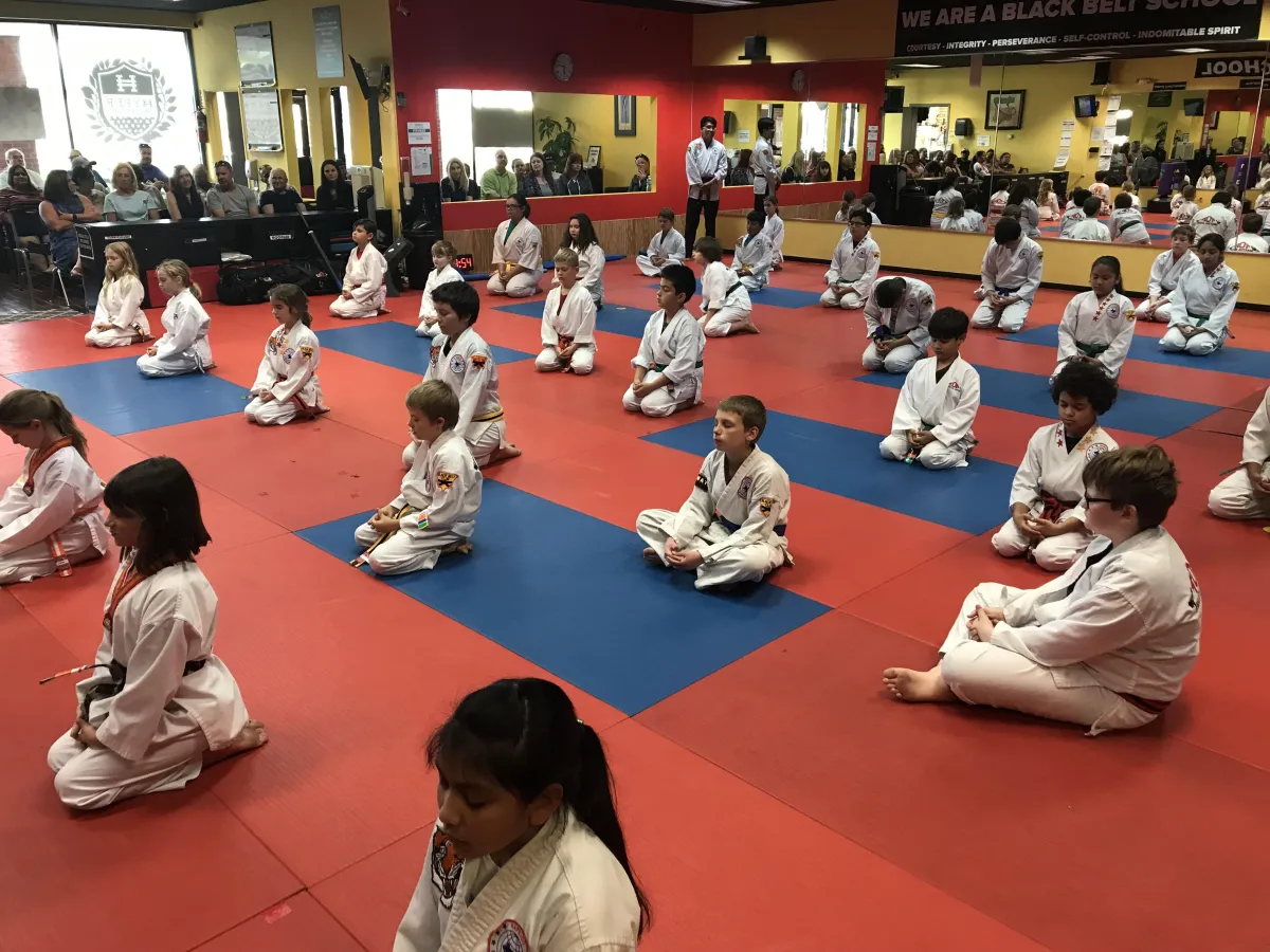 Martial arts instructors reviewing Hapkido curriculum materials together.