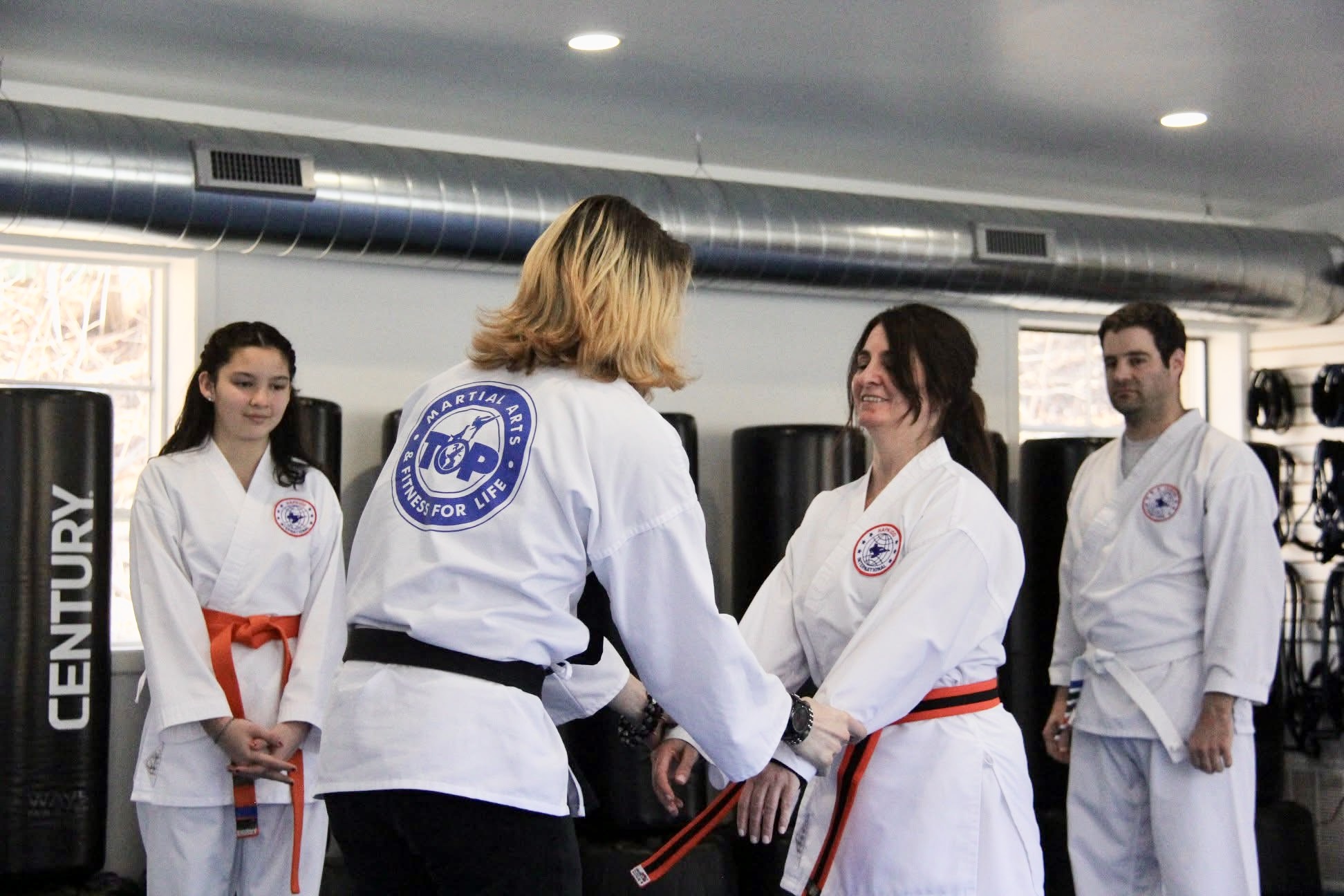 A traditional Hapkido cane in a dojo, featuring a master and student practicing a cane technique.