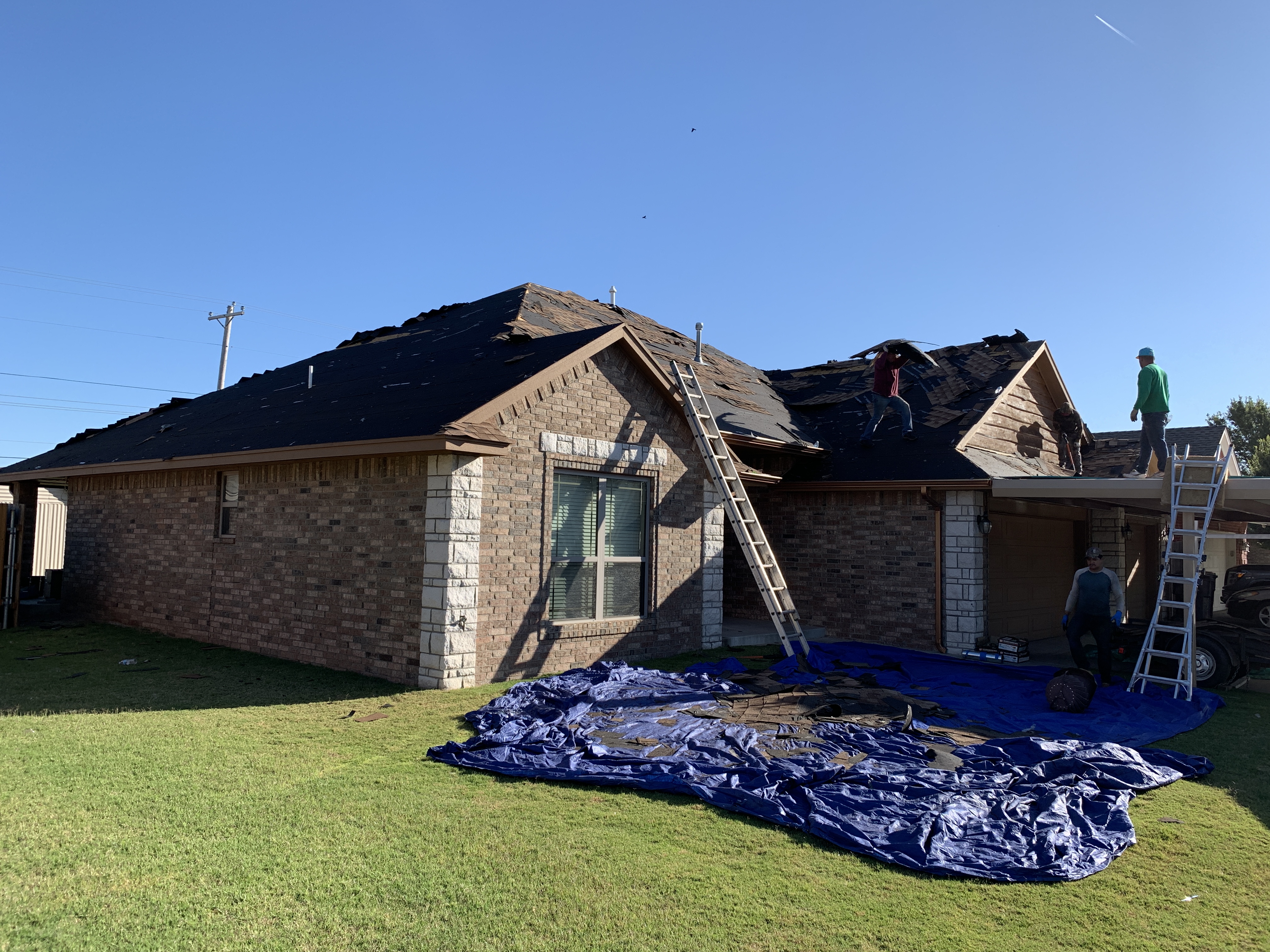 Roof replacement in progress in Oklahoma City with professional roofing crew from 123 Remodeling LLC