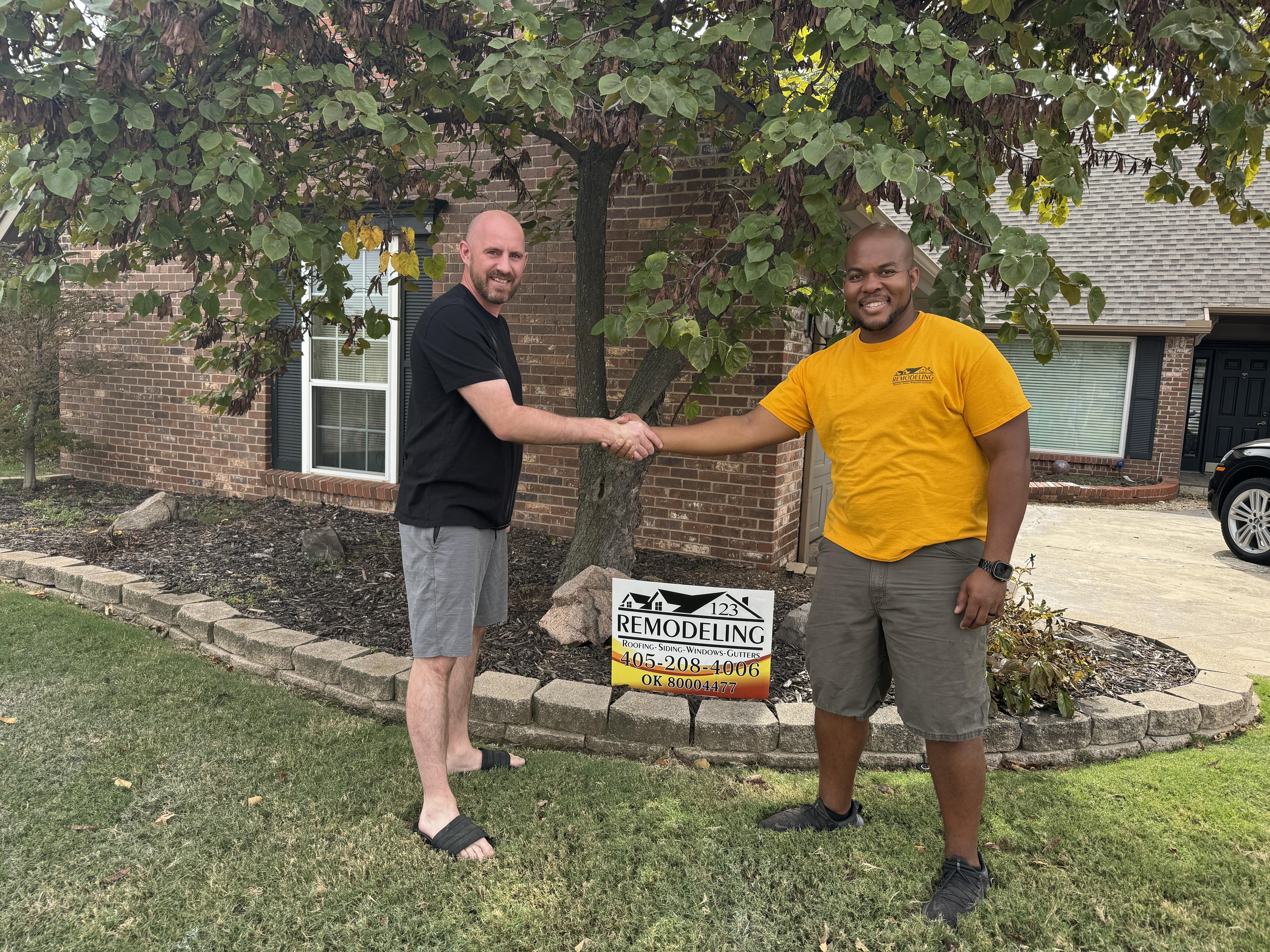 Happy roofing customer in Oklahoma City after roof replacement by 123 Remodeling LLC