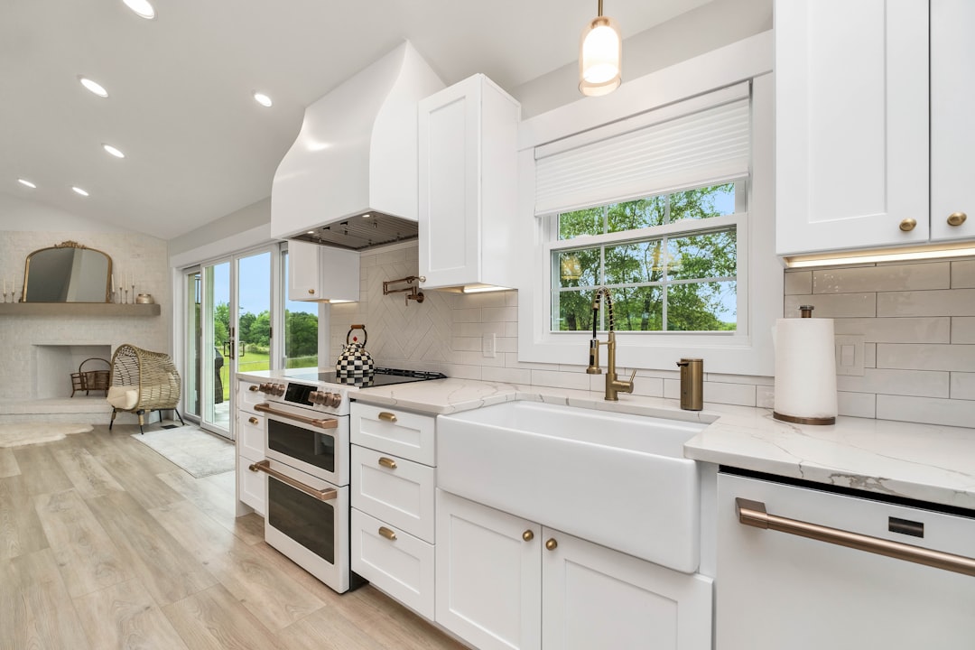Modern white kitchen remodel with farmhouse sink and custom cabinetry
