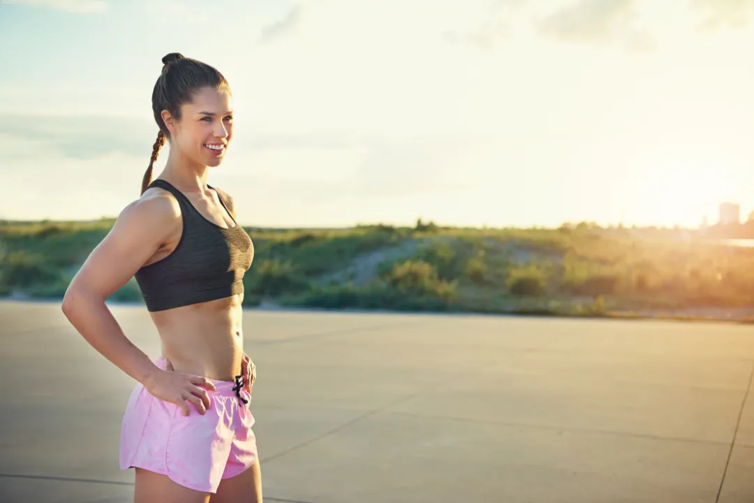 a woman laying on top of a bed holding a mans hand