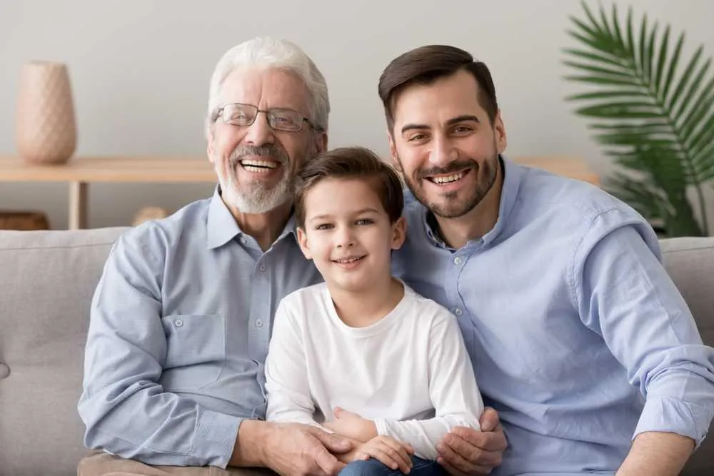 Two older men and a young boy, who are involved in probate administration, sitting on a couch.