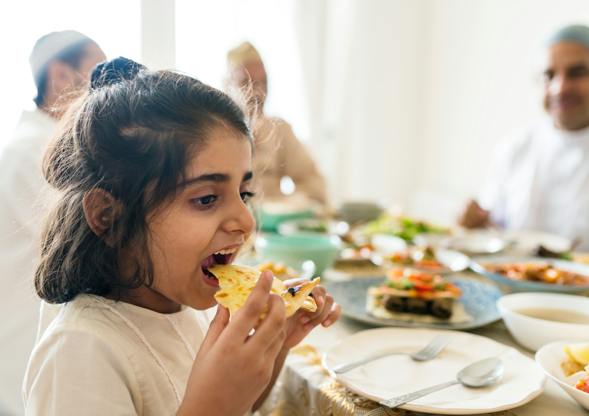 a couple of people holding a bowl of food
