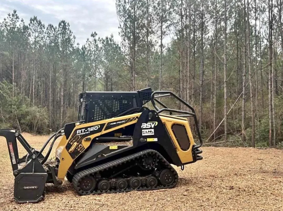 Heavy-duty commercial forestry mulcher processing standing vegetation and dense underbrush
