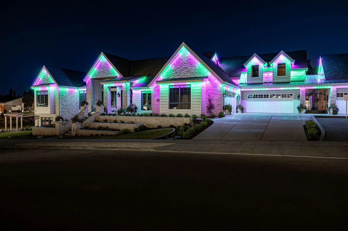 Home lit in purple and green Halloween permanent lighting
