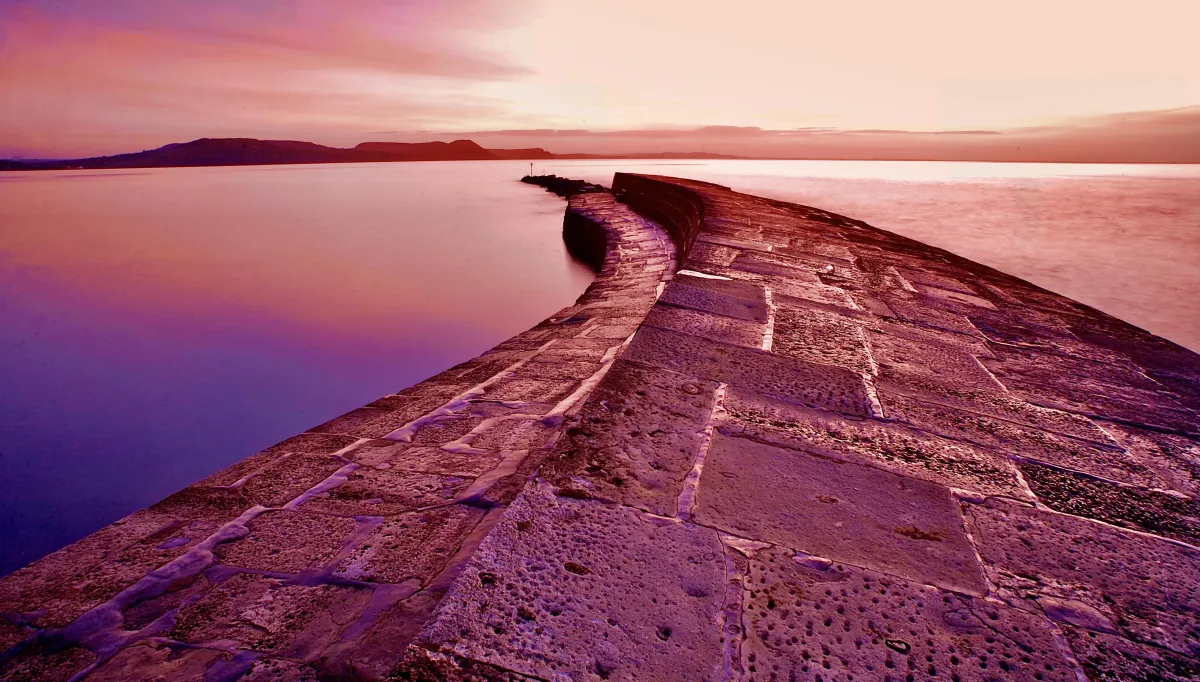 The Cobb Lyme Regis Sunrise just meters from 12 Cobb Road Boutique holiday cottage