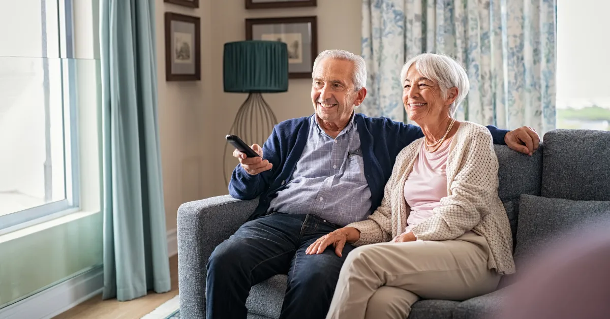 Retired couple enjoying the their day in their living room
