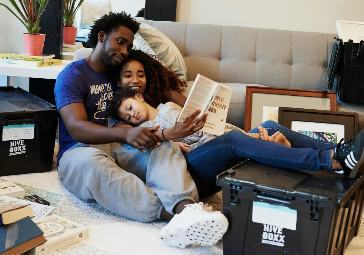 Elderly couple reviews finances at home on couch.