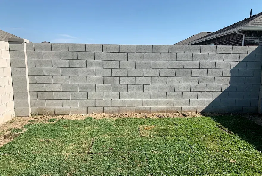 Newly built concrete block privacy wall enclosing a backyard in Warrensville Heights, Ohio.