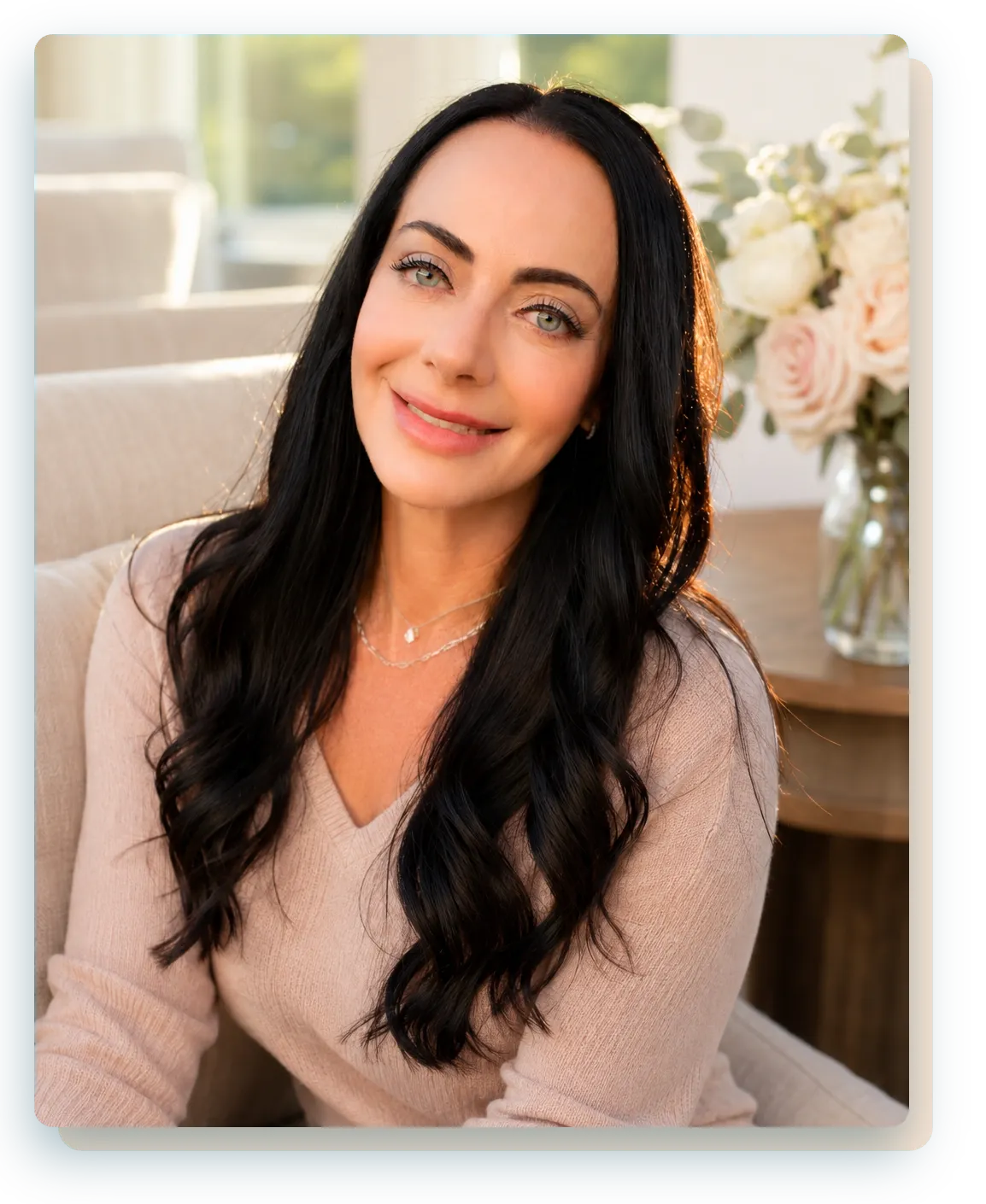 Jen Sells, Nutritional Therapy Practitioner, seated in a bright, warm living room with fresh flowers