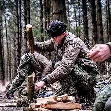 man in blue denim top standing under tree leaf