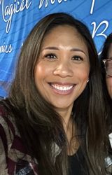 man in blue denim top standing under tree leaf