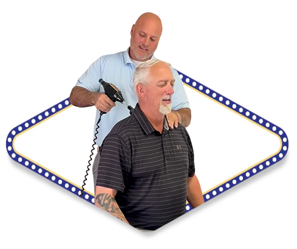 Dr. Dale Kimberlin a top rated chiropractor in Ankeny, Iowa adjusting a patient with a chiropractic tool called an arthrostim.