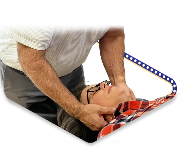 Dr. Dale Kimberlin performing gentle neck adjustment for female patient's vertigo and dizziness treatment at Ankeny Iowa chiropractic wellness center.