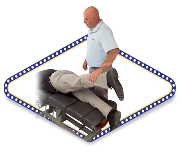 Dr. Dale Kimberlin performing muscle resistance testing on male patient after chiropractic adjustment at Kimberlin Chiropractic Health Systems in Ankeny Iowa for sports performance recover.
