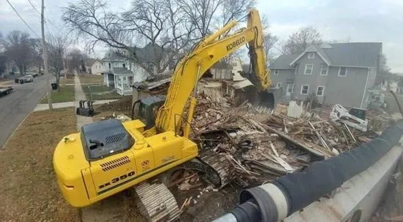 excavator picking up debris