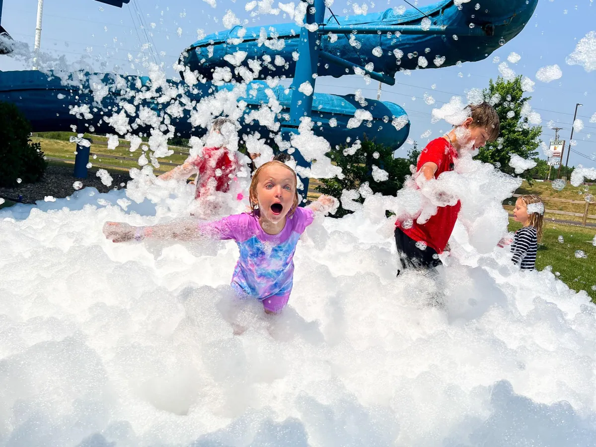 Kids playing in foam in the Chaos Water Park backyard