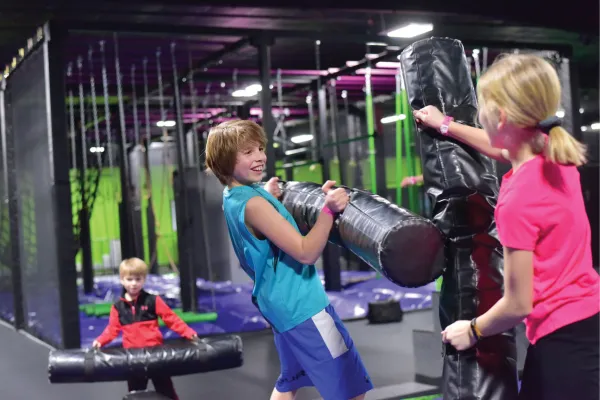 Kids jousting at the trampoline park in Action City