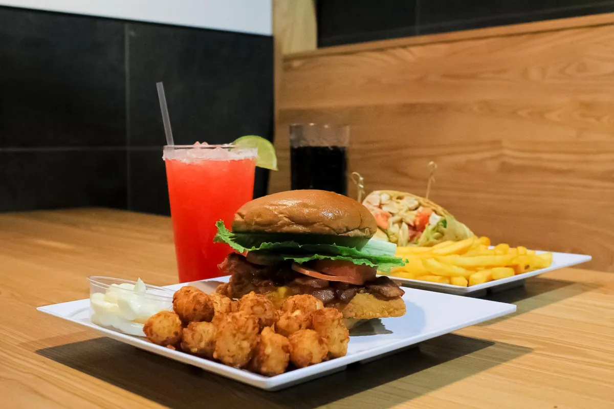 A burger, sandwich wrap,tater tots, fries, and drinks from City Eats